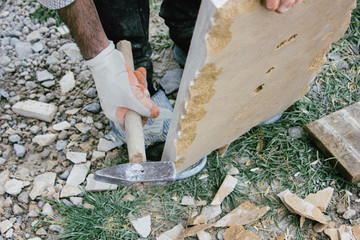 man works with a stone