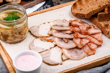 Meat beer snack. Fresh pieces of tasty meat, croutons from dark bread and a cup of broth on a wooden tray