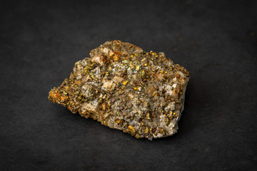 Cat gold yellow gemstone containing fragments of gold alike mineral