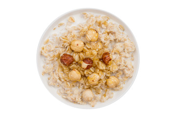 Oatmeal with hazelnut and honey top view isolated on white