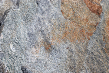 The surface of the marble with a brown tint. Texture of natural stone. This is a horizontal cement-concrete.