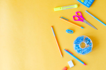 Flat from a variety of stationery on a orange background.