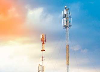 Telecommunication GSM (5G,4G,3G) tower. Cellular phone antennas on a sunset. Receiving and transmitting stations with blue skies on the background.