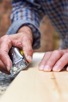 Close up of male hands doing woodwork using tools