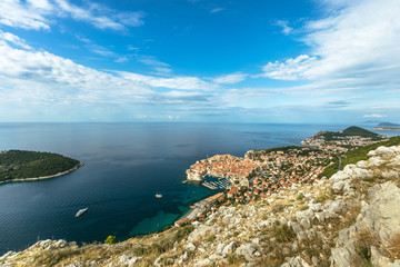 Beautiful townscape of Dubrovnik city and Lokrum island in Croatia, panorama view. Old town and blue bay with boats