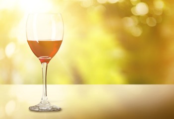 Red wine glass on wooden desk