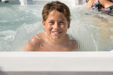 Close view portrait of a happy kid smiling in spa looking to the camera