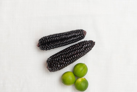 Peruvian Purple corn and lemons. Maiz morado. Top View.