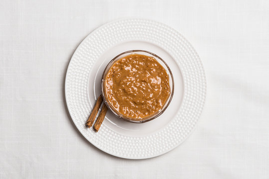 Peruvian dessert: "Arroz zambito" with cinnamon on textured cloth background. Top view.