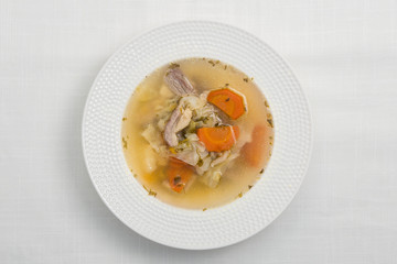 Vegetable soup with meat on white background. Top view.