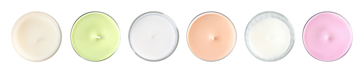 Set with different decorative wax candles on white background, top view. Banner design