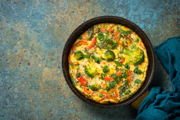 Frittata with fresh vegetables in the skillet.