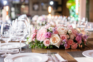 Wine glasses in the foreground. Wedding Banquet or gala dinner. The chairs and table for guests, served with cutlery and crockery.