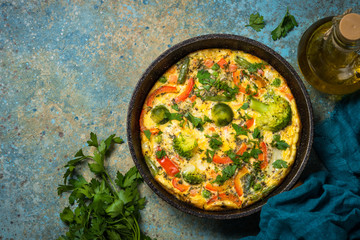 Frittata with fresh vegetables in the skillet.
