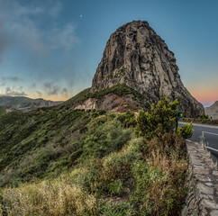 Los roques and famous Agando rock - cult place near Garajonay national park at La Gomera. Old volcanic mountain peaks. Thickets of relic laurels and heather on steep green slopes. Canary. Spain