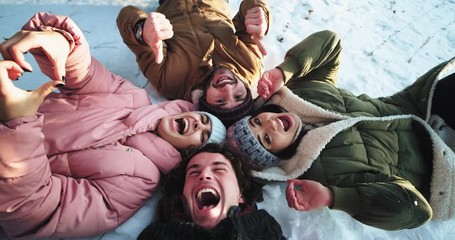 In a winter day group of big friends have a great time together using a camera make some video while enjoying of the fresh air - Powered by Adobe