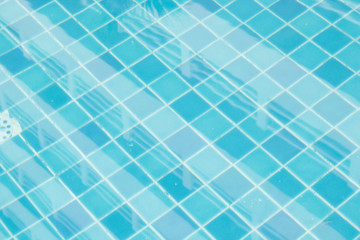 Tile surface, blue pool and reflection of blurred water.