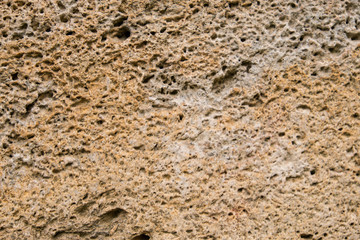 Obraz premium Background of old stone. Limestone is a sedimentary, detrital rock of organic, less often chemogenic origin, consisting of calcium carbonate (CaCO3) in the form of calcite crystals.