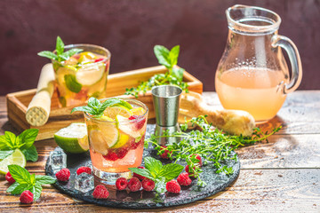 Refreshing mint cocktail mojito with rum, lime and raspberry