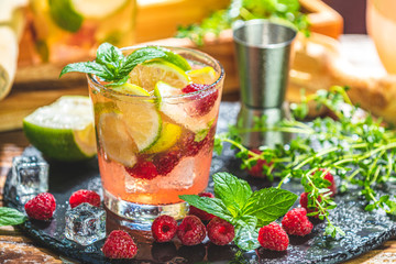 Refreshing mint cocktail mojito with rum, lime and raspberry