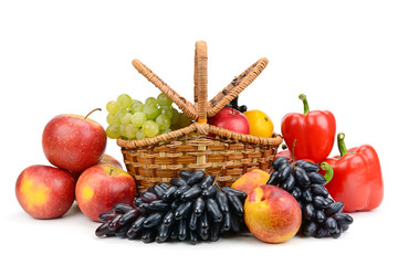 Ripe vegetables and fruits in willow basket isolated on white