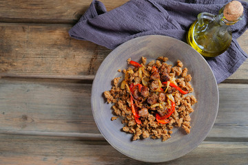 Traditional Spanish dish. teruel Migas with vegetables on wooden table with space for text. The concept for the menus and Windows of restaurant