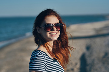 young woman in sunglasses on the beach