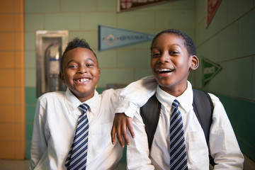 Portrait of smiling students standing in school © Cavan for Adobe