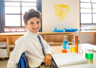 School boy (10-11) in science class, with lab notebook © Cavan for Adobe