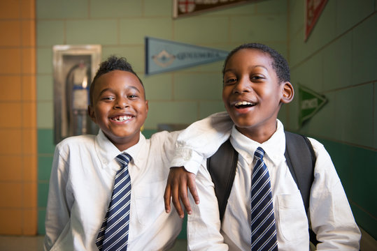 Portrait of smiling students standing in school