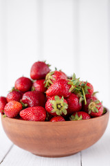 ripe and juicy strawberries are in a plate on the table. vitamins and minerals in the same plate