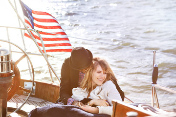 Obraz premium Young couple relaxing on yacht