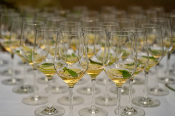 Beautifully decorated welcome drink - a glass of Prosecco or champagne with lime inside, served as a welcome drink on a party, event, wedding reception or banquet.