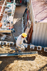 Fototapeta premium Construction worker on a heavy site doing hard work.
