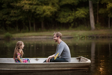 Father and daughter (4-5) face to face on rowboat © Cavan for Adobe