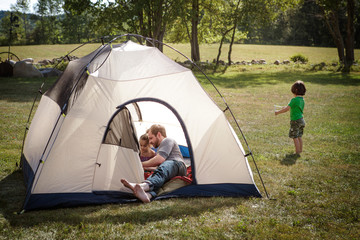 Father playing with daughters (4-5) in tent © Cavan for Adobe