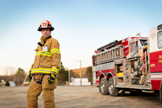 Firefighter standing in front of fire engine