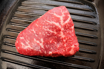 Raw Fresh Marbled Meat Beef on a grill pan ready for cooking.