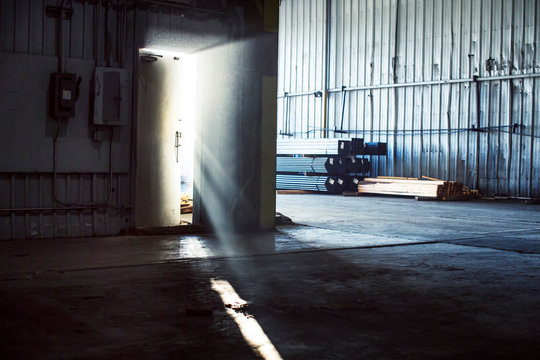 Warehouse door ajar in sunlight