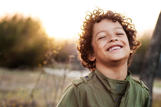 Portrait of boy (6-7) smiling in meadow