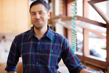 Fototapeta premium Carpenter posing in workshop