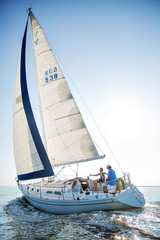 Naklejka premium People travelling by sailing yacht