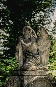 Marble statue and an ancient abandoned Gothic cemetery