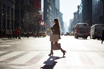 Side view of woman walking on pedestrian crossing © Cavan for Adobe