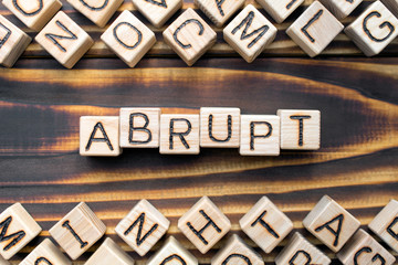 abrupt wooden cubes with letters, rude and unfriendly concept, around the cubes random letters, top...