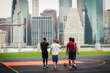 Rear view of basketball players in basketball court © Cavan for Adobe