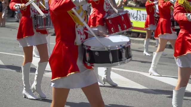 Street performance on the occasion of the holiday. Young girls drummer in red at the parade