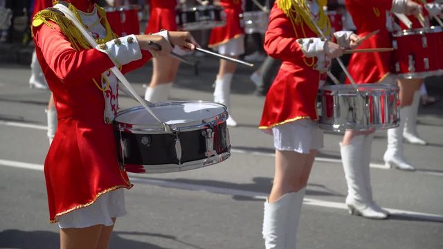 Young drummers line up and beat the melody. Close-up of female hands drummers are knocking in the drum of their sticks. Slow motion