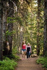 Obraz premium Mother with adult daughter walking in forest