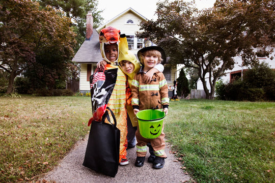 Portrait of smiling children in costumes during Halloween